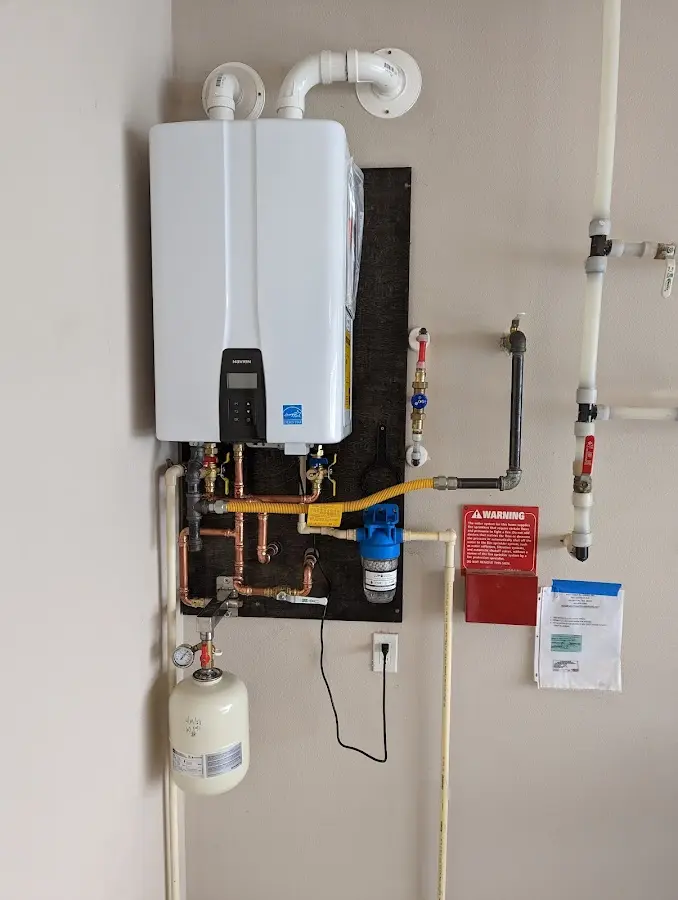 Professional plumber installing copper piping in a Manteca home